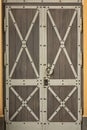 Closeup Of Reinforced Double Leaf Wooden Door With Iron Element