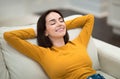 Closeup of relaxed young woman chilling on couch at home Royalty Free Stock Photo