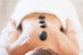 Closeup on relaxed young woman receiving hot stone massage Royalty Free Stock Photo