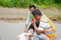 Closeup rescue workers using radio communication helping woman driver from car accident on road Royalty Free Stock Photo