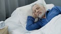 Closeup of retired man sleeping in bed in the morning, recovery time, health Royalty Free Stock Photo