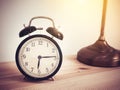 Closeup retro alarm clock on wooden table with copy space