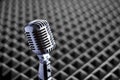 Closeup of retro condenser microphone on acoustic foam panel background Royalty Free Stock Photo