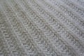 Closeup of rib stitch pattern on white knitwork diagonal wales