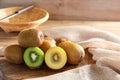 Closeup ripe golden kiwi fruit and green kiwi fruit on wooden background. Healthy fruits concept