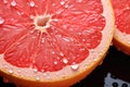 closeup ripe juice sliced red grapefruit in water drops top view on black background Royalty Free Stock Photo