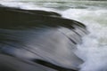 Closeup river flow with little waterfall