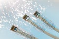 Closeup of RJ45 UTP LAN on the background of optical fibers with blurred lights Royalty Free Stock Photo