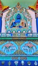 closeup of richly ornamented indigo colored buddha sitting on dais