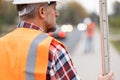 Road construction worker in orange vest an helmet Royalty Free Stock Photo