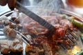 Closeup Roast pork on a charcoal stove is about to be cooked. Royalty Free Stock Photo