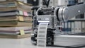 Closeup of robotic scanner printing labels after digitizing case files the printer in clear focus with blurred stacks of Royalty Free Stock Photo