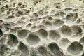 Closeup rock erosion holes sea wall. Royalty Free Stock Photo