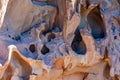 Closeup of a rock formation wall with holes, grooves, erosions and irregular texture Royalty Free Stock Photo