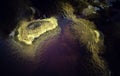 Closeup of rocks in red acidic and polluted Rio Tinto River due to mining, in Spain Royalty Free Stock Photo