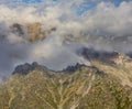 rocky mountain chain in dense clouds