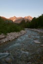 Closeup of a rocky river with mountain at sunrise on background Royalty Free Stock Photo