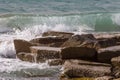 closeup rocky sea cape among splashing waves