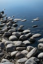 Closeup of a the rocky shoreline of a lake. Royalty Free Stock Photo