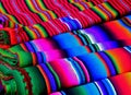 Closeup of rolls of multi-colored striped fabrics