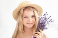 Closeup romantic portrait Charming little blond girl in a straw hat holds a bouquet of lavender. Summer flowers, aromatherapy. An Royalty Free Stock Photo