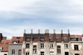 Closeup of rooftops of old residential houses with chimneys under a cloudy blue sky Royalty Free Stock Photo