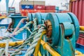 closeup of ropes and winches securing containers on deck during transit