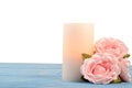 Closeup roses and candle on blue wood