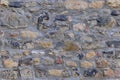 Closeup rough basalt texture of old medieval stone wall, brown natural backdrop, stone, bridge road, pavement, pattern, texture, Royalty Free Stock Photo