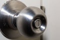 Closeup of a round door handle knob with push lock