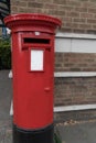 Closeup round metal mailbox brick wall London