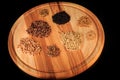 closeup round wooden board with assorted groat handfuls