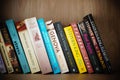 Closeup of row of books including Stephen King on a wooden shelf. Royalty Free Stock Photo
