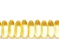 Closeup row of capsules fish oil with Omega 3 on white background. Seamless pattern.