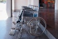 Closeup row of empty wheelchairs parking outdoor prepared for for older people and disabled passengers