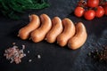 closeup row of short thick sausages with dill and tomatoes Royalty Free Stock Photo