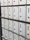 Closeup of rows of numbered metal post office mailboxes Royalty Free Stock Photo