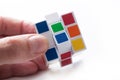 Closeup of Rubik`s cube in hand on white background Royalty Free Stock Photo