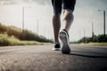 Closeup of runner shaved feet in running shoes going for a run on the road at sunrise or sunset.