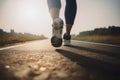 Closeup of runner shaved feet in running shoes going for a run on the road at sunrise or sunset.