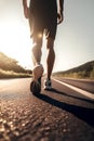 Closeup of runner shaved feet in running shoes going for a run on the road at sunrise or sunset.