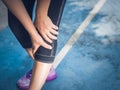 Closeup runner sport knee injury. Woman in pain while running.