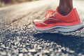 closeup of running shoes midstride on asphalt Royalty Free Stock Photo