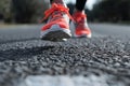 closeup of running shoes midstride on asphalt Royalty Free Stock Photo