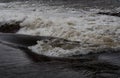 Closeup of rushing water during high tide at Saale river in Thuringia, Germany - a Royalty Free Stock Photo