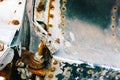 Closeup of a rusty decaying metal part and bolt on an old military aircraft