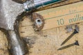 Closeup of rusty hammer, nails and meter yard stick on scratched Royalty Free Stock Photo