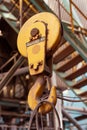 Closeup rusty iron crane hook in front of industrial plant background Royalty Free Stock Photo