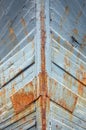 Closeup of rusty iron ship walls with grey paint on it Royalty Free Stock Photo