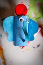 Closeup s vertical shot of a small cute blue elephant handmade with paints and cardboard tube